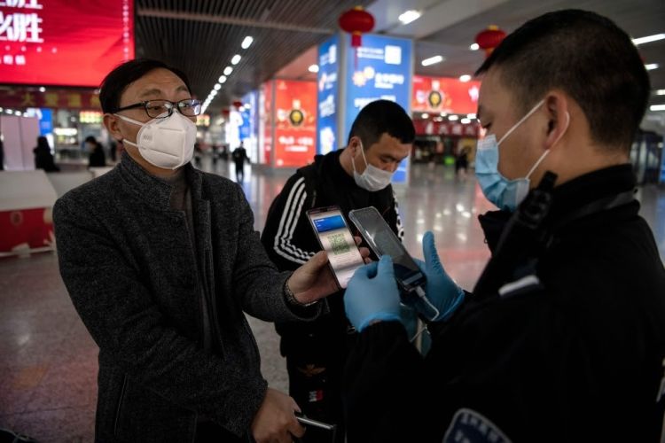 مواطن صيني يُظهر رمز الاستجابة السريع على هاتفه الذكي